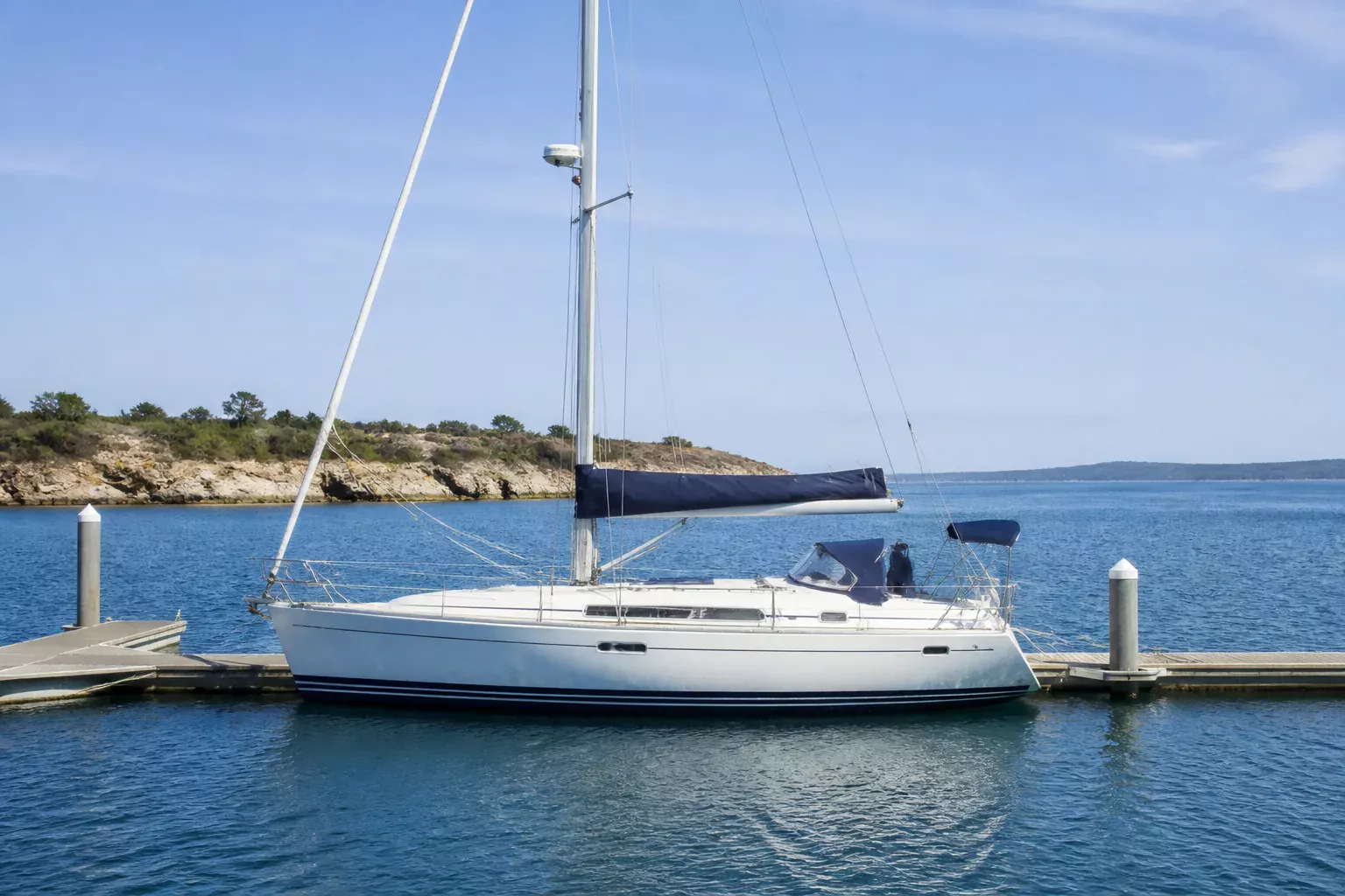 Sailboat docked at sunny marina